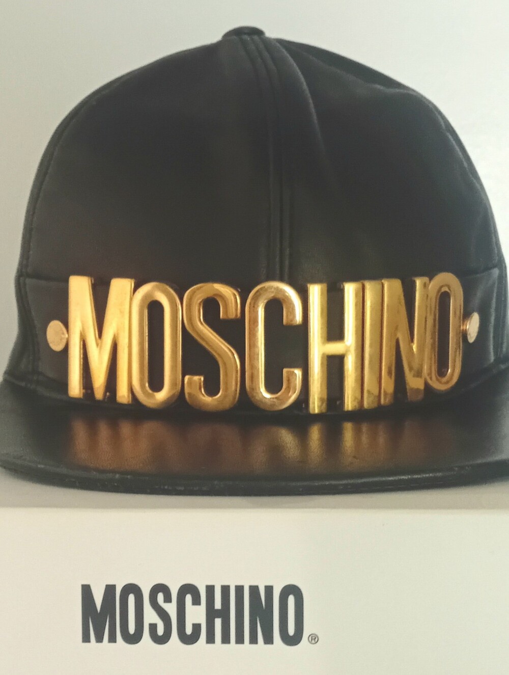Moschino Black Leather Cap with Gold Logo Plaque